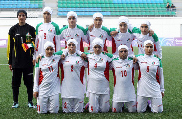 Iran's girls' football team pose for a group picture before the start of Turkey versus Iran girls' preliminary match of the Singapore 2010 Youth Olympic Games (YOG) played at the Jalan Besar Stadium in Singapore, Aug 12, 2010. Photo: SPH-SYOGOC/Seyu Tzyy Wei